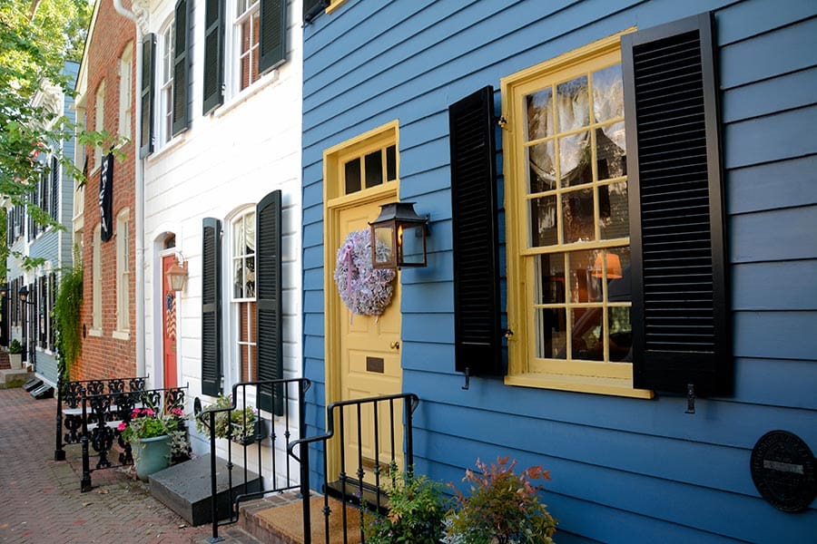 Row Homes Painted in Bright Colors, With Brick Sidewalks and Wooden Shutters